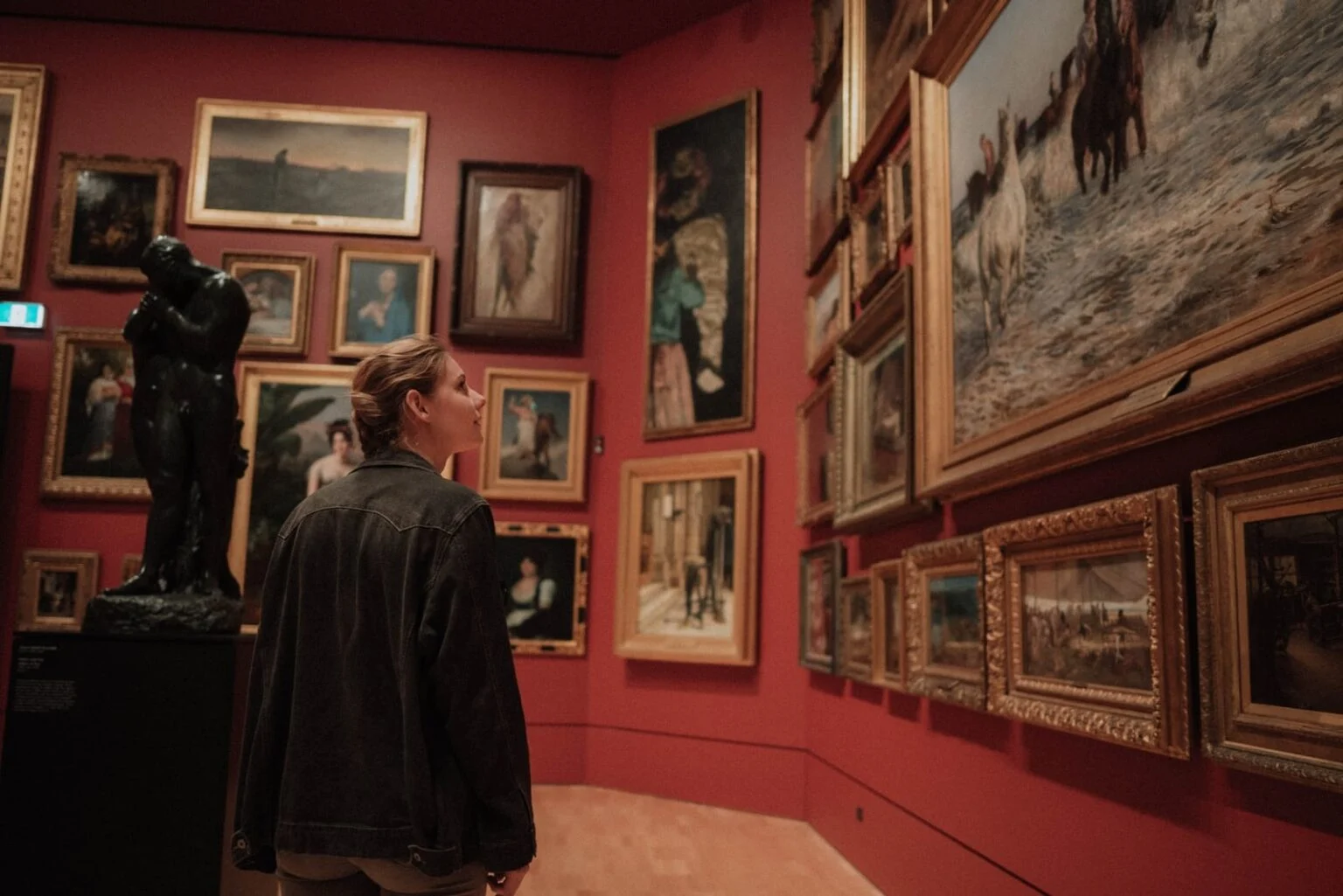 Visitor viewing classic paintings in a museum
