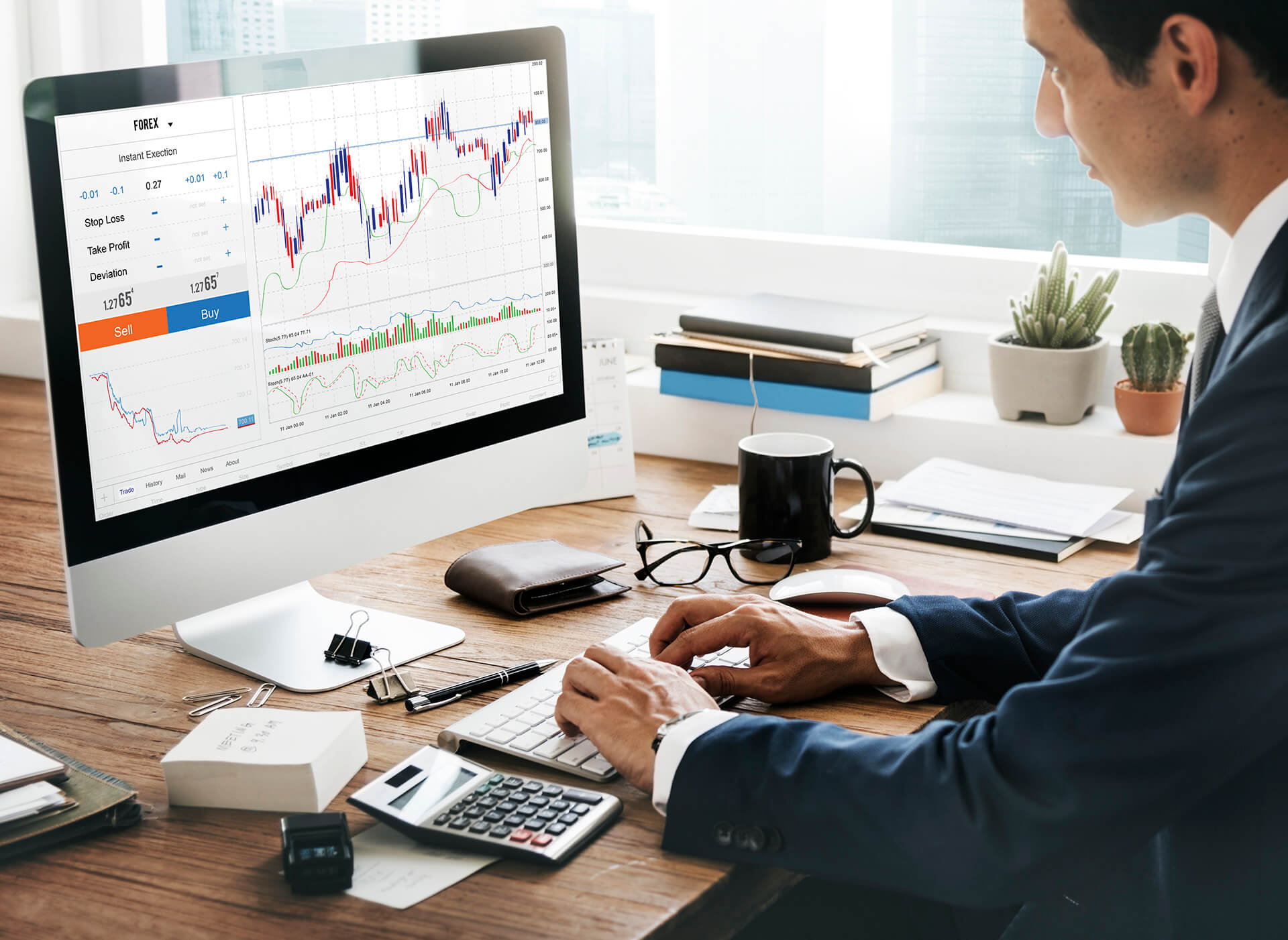 Businessman analyzing trading charts on desktop screen